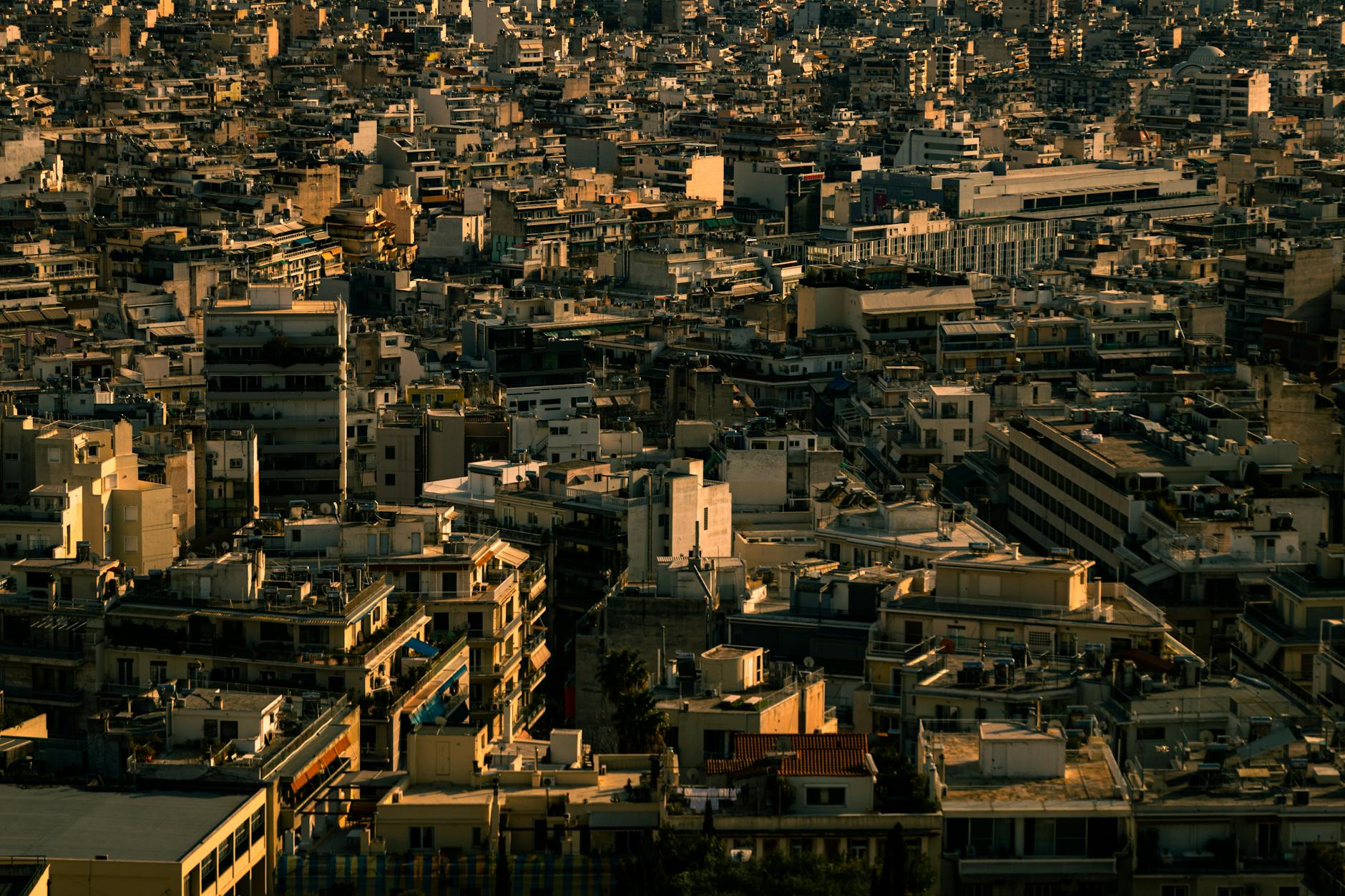 Aerial view of Athens cityscape at twilight showcasing dense urban architecture.
