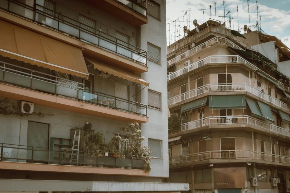 View of urban apartment buildings with balconies in Athens, showcasing Mediterranean architecture.
