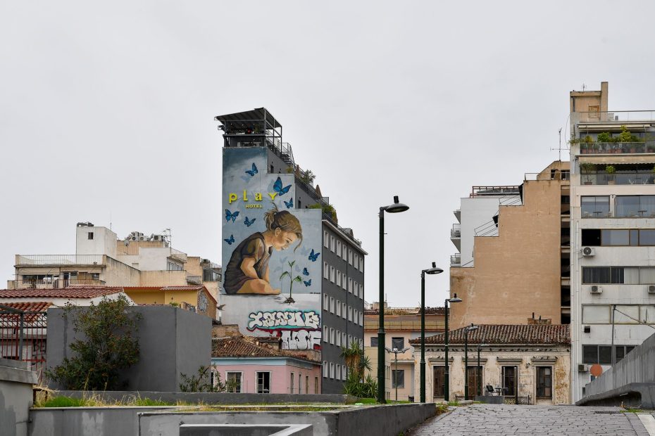 Vibrant street art mural on a building facade in Athens, Greece, showcasing urban culture.